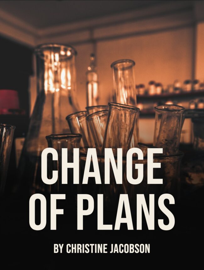 Dim amber laboratory glassware in the dark, with the title Change of Plans by Christine Jacobson