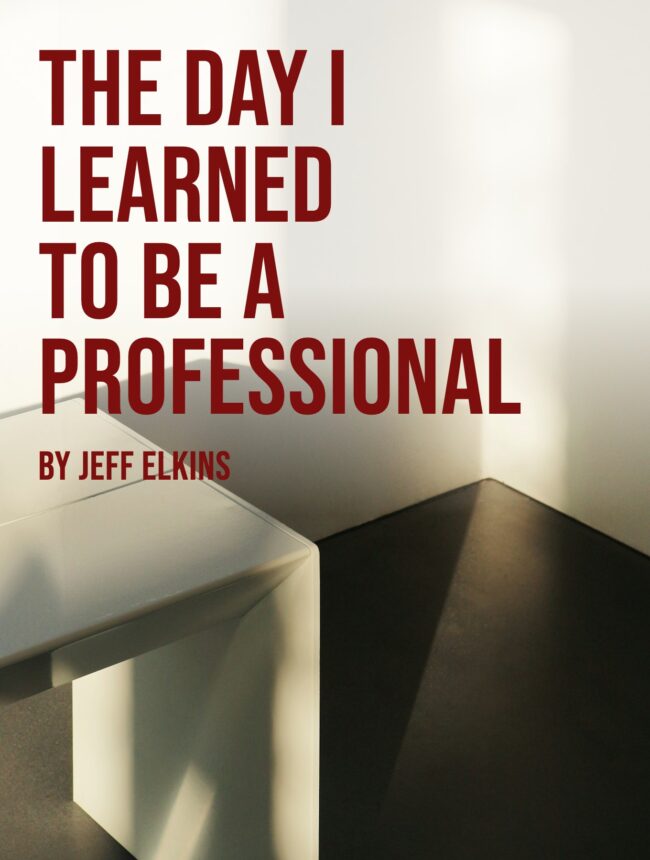 a white desk corner in a sunlit empty room, with the title The Day I Learned to Be a Professional by Jeff Elkins